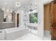 Stunning main bathroom with a soaking tub, separate shower, dual vanities, marble floors, and custom wood cabinets at 4375 Mount Paran Pkwy Nw, Atlanta, GA 30327