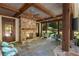Covered outdoor seating area with a stone fireplace and ceiling fans, perfect for entertaining at 4375 Mount Paran Pkwy Nw, Atlanta, GA 30327