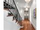 Elegant staircase features dark metal railings, hardwood steps and floors, and white walls at 4375 Mount Paran Pkwy Nw, Atlanta, GA 30327