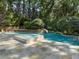 A backyard pool with a tiled spa, slide and mature trees create a fun and relaxing outdoor oasis at 4375 Mount Paran Pkwy Nw, Atlanta, GA 30327