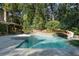 A backyard pool with a tiled spa, slide and mature trees create a fun and relaxing outdoor oasis at 4375 Mount Paran Pkwy Nw, Atlanta, GA 30327