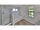 Bathroom with separate shower and tub, plus a window for natural light at 516 N Shore Rd, Lithonia, GA 30058
