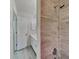 Bathroom featuring updated tiled shower, vanity with sink, and tile flooring at 516 N Shore Rd, Lithonia, GA 30058