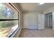 Bright bedroom with large window offering outdoor views; features neutral walls and carpeting at 516 N Shore Rd, Lithonia, GA 30058