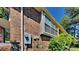 Side view of brick house featuring large windows and a lush green bush at 516 N Shore Rd, Lithonia, GA 30058