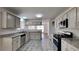 Well-lit kitchen with granite counters, stainless steel appliances, and ample cabinet space at 516 N Shore Rd, Lithonia, GA 30058