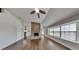 Bright living room featuring hardwood floors, brick fireplace, and large windows for ample natural light at 516 N Shore Rd, Lithonia, GA 30058
