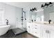 Modern bathroom with dual vanity sinks, a freestanding tub, and a separate glass-enclosed shower at 569 Hope Sw St, Atlanta, GA 30310