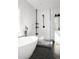 Bathroom featuring a modern shower and bathtub with black fixtures, herringbone tile, and a hexagon tile floor at 569 Hope Sw St, Atlanta, GA 30310