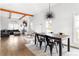Bright dining room with modern lighting, wood floors, and an open connection to living area at 569 Hope Sw St, Atlanta, GA 30310