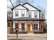 Charming two-story home with a welcoming front porch and a bright yellow door at 569 Hope Sw St, Atlanta, GA 30310