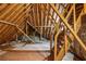 Unfinished attic space with exposed wooden beams and stair access at 980 Ector Chase Nw, Kennesaw, GA 30152