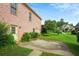 Brick house back exterior with a concrete patio and a grassy yard at 980 Ector Chase Nw, Kennesaw, GA 30152