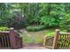 Stairway down to a beautifully landscaped backyard with mature trees and stone path at 980 Ector Chase Nw, Kennesaw, GA 30152
