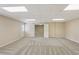 Finished basement with neutral carpet, open doorway, and access to the backyard at 980 Ector Chase Nw, Kennesaw, GA 30152