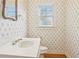 Powder bathroom with wallpaper, tile flooring, and a white vanity at 980 Ector Chase Nw, Kennesaw, GA 30152