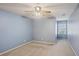 Empty bedroom with pale blue walls, neutral carpet and a window at 980 Ector Chase Nw, Kennesaw, GA 30152