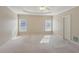 Spacious main bedroom featuring a ceiling fan, tray ceilings and neutral carpet at 980 Ector Chase Nw, Kennesaw, GA 30152