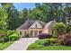 Beautiful brick home with lush landscaping, mature trees, and a long driveway, set on a well-manicured lawn at 980 Ector Chase Nw, Kennesaw, GA 30152