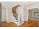 Welcoming foyer with hardwood floors, staircase, and elegant chandelier, offering a glimpse into the adjacent living spaces at 980 Ector Chase Nw, Kennesaw, GA 30152