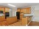 Functional kitchen featuring wood cabinets, black appliances, granite countertops and an island, perfect for meal prep at 980 Ector Chase Nw, Kennesaw, GA 30152