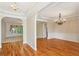 Open-concept living and dining areas featuring hardwood floors, elegant chandeliers, and abundant natural light at 980 Ector Chase Nw, Kennesaw, GA 30152