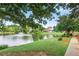 Picturesque pond and walking path with benches and luxury homes in the background at 980 Ector Chase Nw, Kennesaw, GA 30152