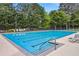 Large community swimming pool with lane markers and lounge chairs at 980 Ector Chase Nw, Kennesaw, GA 30152