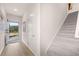 Inviting entryway with hardwood floors, a staircase, and a view of the front yard through the front door at 1122 Edinberg Dr, Villa Rica, GA 30180
