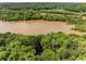 Aerial shot of a wooded lot with a lake visible in the background at 130 River Ne Lndg, Sandy Springs, GA 30350