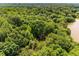 Secluded wooded property with a glimpse of the house roof and waterfront access enhancing privacy and natural beauty at 130 River Ne Lndg, Sandy Springs, GA 30350