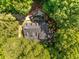 Aerial view of the home showcasing the roof and surrounding lush landscaping at 130 River Ne Lndg, Sandy Springs, GA 30350