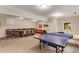 Entertainment space with a ping pong table and long wood table with chairs next to a built-in bookcase at 130 River Ne Lndg, Sandy Springs, GA 30350