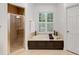 Beautiful bathroom featuring a shower, soaking tub with modern fixtures, and a bright, airy feel at 130 River Ne Lndg, Sandy Springs, GA 30350