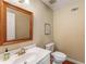 Bright bathroom with a framed mirror, vanity with gold faucet, and toilet at 130 River Ne Lndg, Sandy Springs, GA 30350