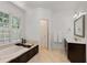 Bright bathroom with soaking tub, dark wood vanity, and natural light at 130 River Ne Lndg, Sandy Springs, GA 30350