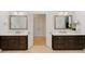 Bathroom featuring double sinks with white countertops and dark wood cabinets with gold hardware at 130 River Ne Lndg, Sandy Springs, GA 30350