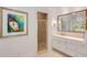 Bathroom featuring a shower with gold trim and a vanity with framed mirror and light fixtures at 130 River Ne Lndg, Sandy Springs, GA 30350