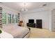 Bright bedroom featuring large windows, a modern light fixture, and comfortable furniture at 130 River Ne Lndg, Sandy Springs, GA 30350