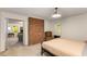 Bedroom with a brick accent wall, neutral carpet, access to another room, and chair at 130 River Ne Lndg, Sandy Springs, GA 30350