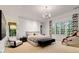 This primary bedroom suite features large windows, a massage chair, and a sitting area with a plush chair at 130 River Ne Lndg, Sandy Springs, GA 30350