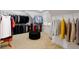 Large walk-in closet featuring hanging racks and an ottoman at 130 River Ne Lndg, Sandy Springs, GA 30350
