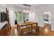 Bright dining room with wood floors, modern lighting fixture, dining table with bench and access to the outdoors at 130 River Ne Lndg, Sandy Springs, GA 30350