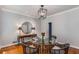 Elegant dining room with hardwood floors, modern light fixture, and round glass-top table at 130 River Ne Lndg, Sandy Springs, GA 30350