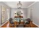 Formal dining room featuring a glass table, elegant chandelier, and hardwood floors at 130 River Ne Lndg, Sandy Springs, GA 30350
