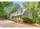 Inviting gray home with a well-manicured lawn, red front door, and a long driveway at 130 River Ne Lndg, Sandy Springs, GA 30350