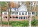 Stately two-story home featuring a brick foundation and multi-paned windows, surrounded by fall foliage at 130 River Ne Lndg, Sandy Springs, GA 30350