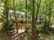 Secluded two-story home with brick accents and multiple windows, nestled among mature trees at 130 River Ne Lndg, Sandy Springs, GA 30350