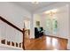Elegant foyer with hardwood floors, staircase, view to dining room, and entrance to the backyard at 130 River Ne Lndg, Sandy Springs, GA 30350