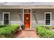 Elegant front door with sidelights, flanked by manicured hedges and brick walkway at 130 River Ne Lndg, Sandy Springs, GA 30350